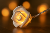 Decorative light shaped like a rose with a warm glow on a blurred background